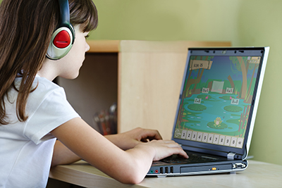 Girl playing Reflex on laptop